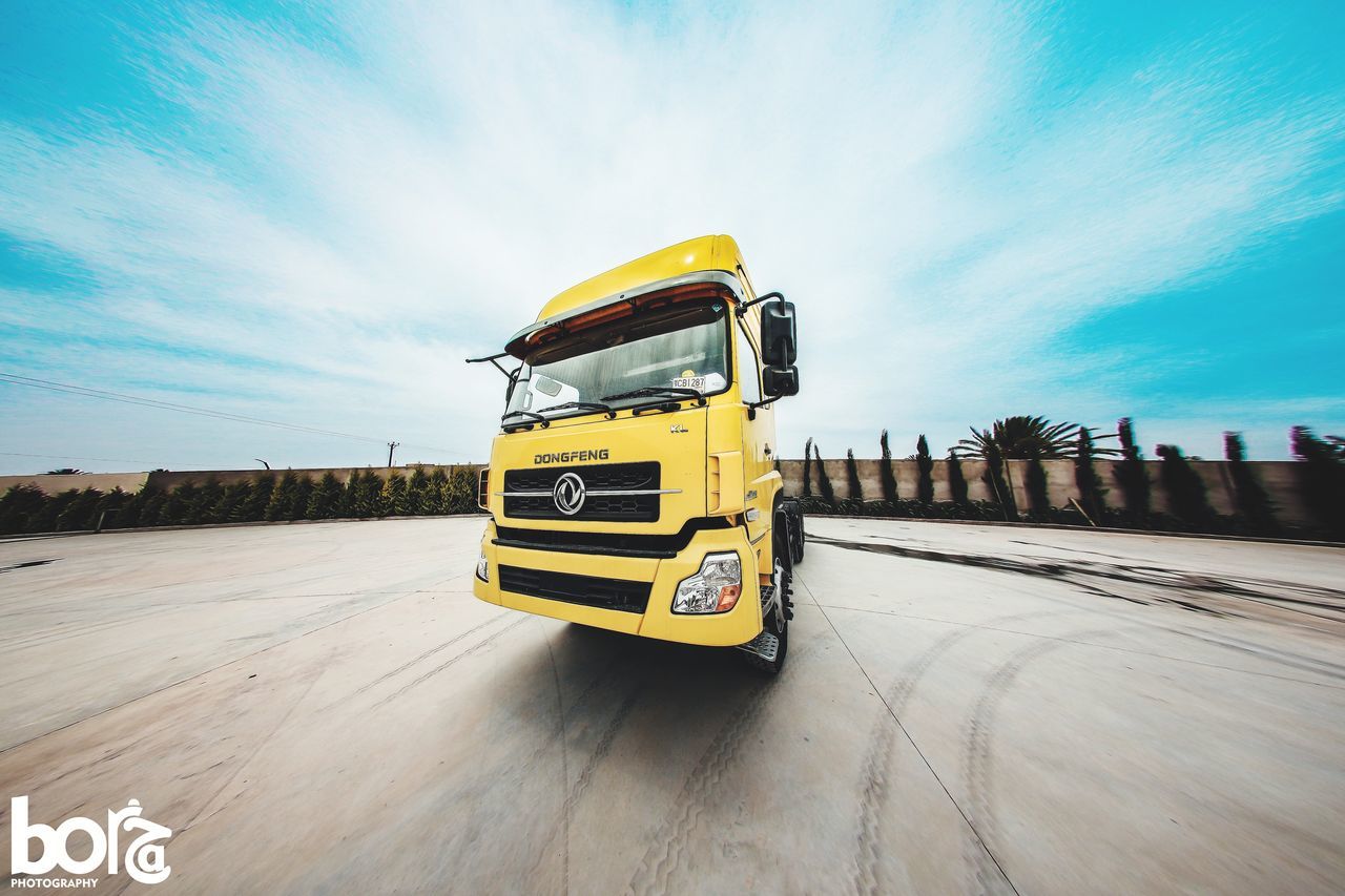 transportation, mode of transportation, road, sky, car, vehicle, motion, yellow, motor vehicle, driving, speed, land vehicle, nature, travel, transport, racing, automobile, auto racing, screenshot, cloud, on the move, bus, truck, blue, outdoors, landscape, sports, blurred motion