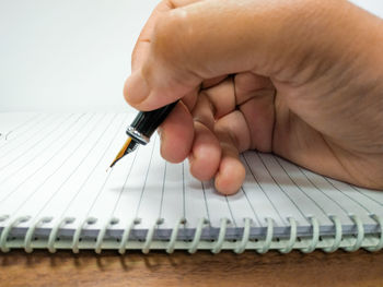 Close-up of hand holding book