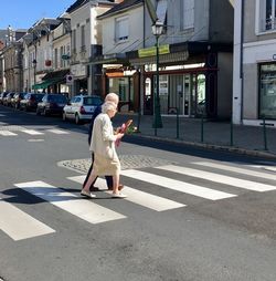 Full length of man crossing road