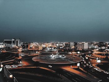 High angle view of illuminated buildings against sky at night