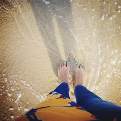 Low section of woman standing on beach