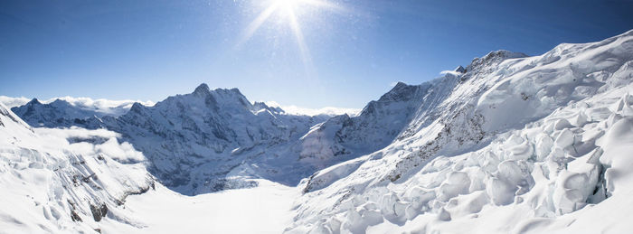 Panoramic view of snowcapped mountains against sky