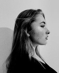 Close-up portrait of young woman against white background