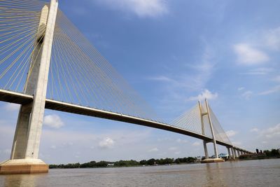 Low angle view of suspension bridge against sky