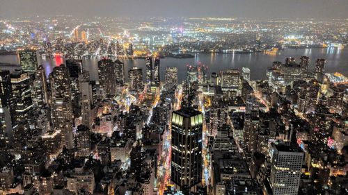 High angle view of city lit up at night