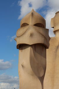 Low angle view of statue against cloudy sky