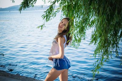 Young, beautiful girl on the river bank