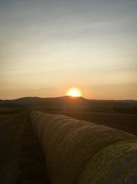 Scenic view of field against sky during sunset