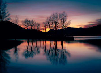 Scenic view of lake against sky during sunset