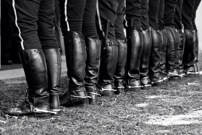 Low section of people standing in boots