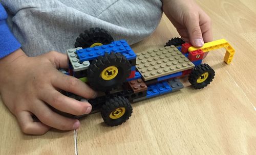 High angle view of baby playing with toy car at home