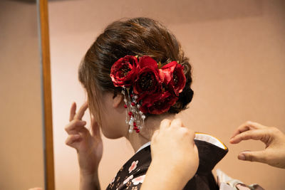 Rear view of woman holding pink flower