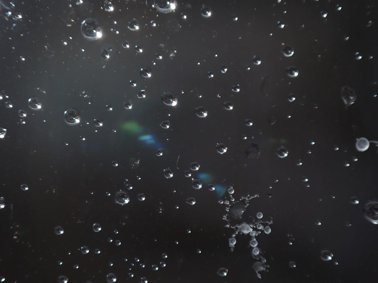 CLOSE-UP OF BUBBLES AGAINST SKY AT NIGHT