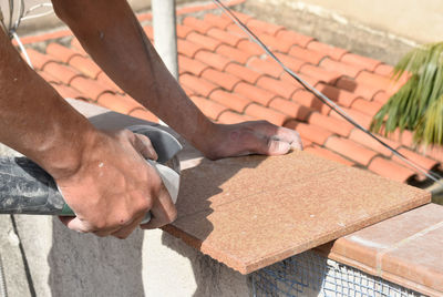 Hands of man working in masonry, unrecognisable