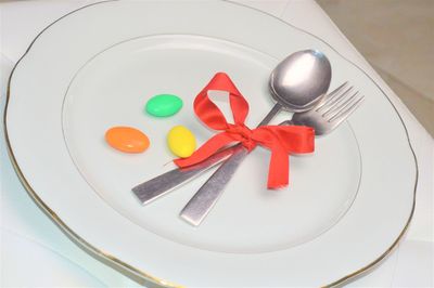 High angle view of candies in plate on table