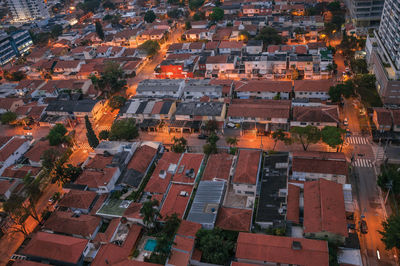 Streets lights and house roofs in the early morning lights, at the city of sao paulo, brazil.