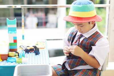 Rear view of boy looking at camera