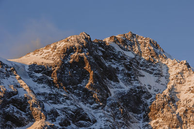 Scenic view of snowcapped mountains against clear sky