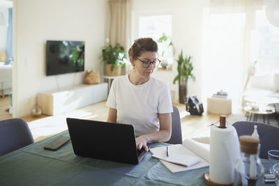 Woman using laptop at home