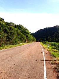 Road amidst trees against sky