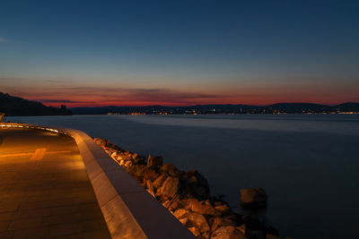 Scenic view of river against clear sky during sunset