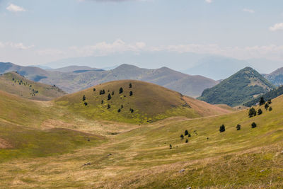 Scenic view of mountains against cloudy sky