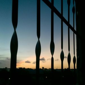 Close-up of silhouette trees against sky at sunset