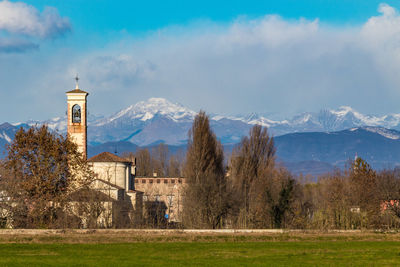 Trees and buildings against sky