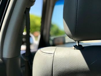 Close-up of seat in car during sunny day
