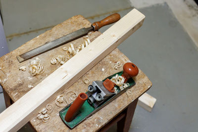 Planer, file and wooden block on a stool