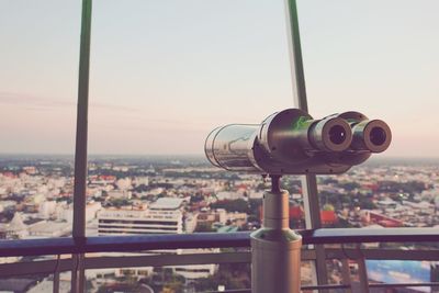 Close-up of coin-operated binoculars against sky