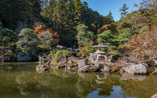 Full frame view of zen garden with reflecting water and autumn fall colors