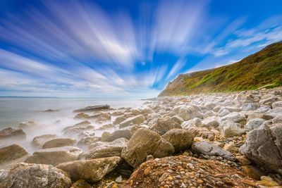 Scenic view of beach against blue sky