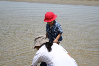 Women with son on shore at beach