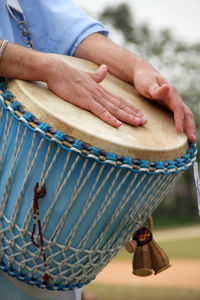 Cropped image of man playing drum