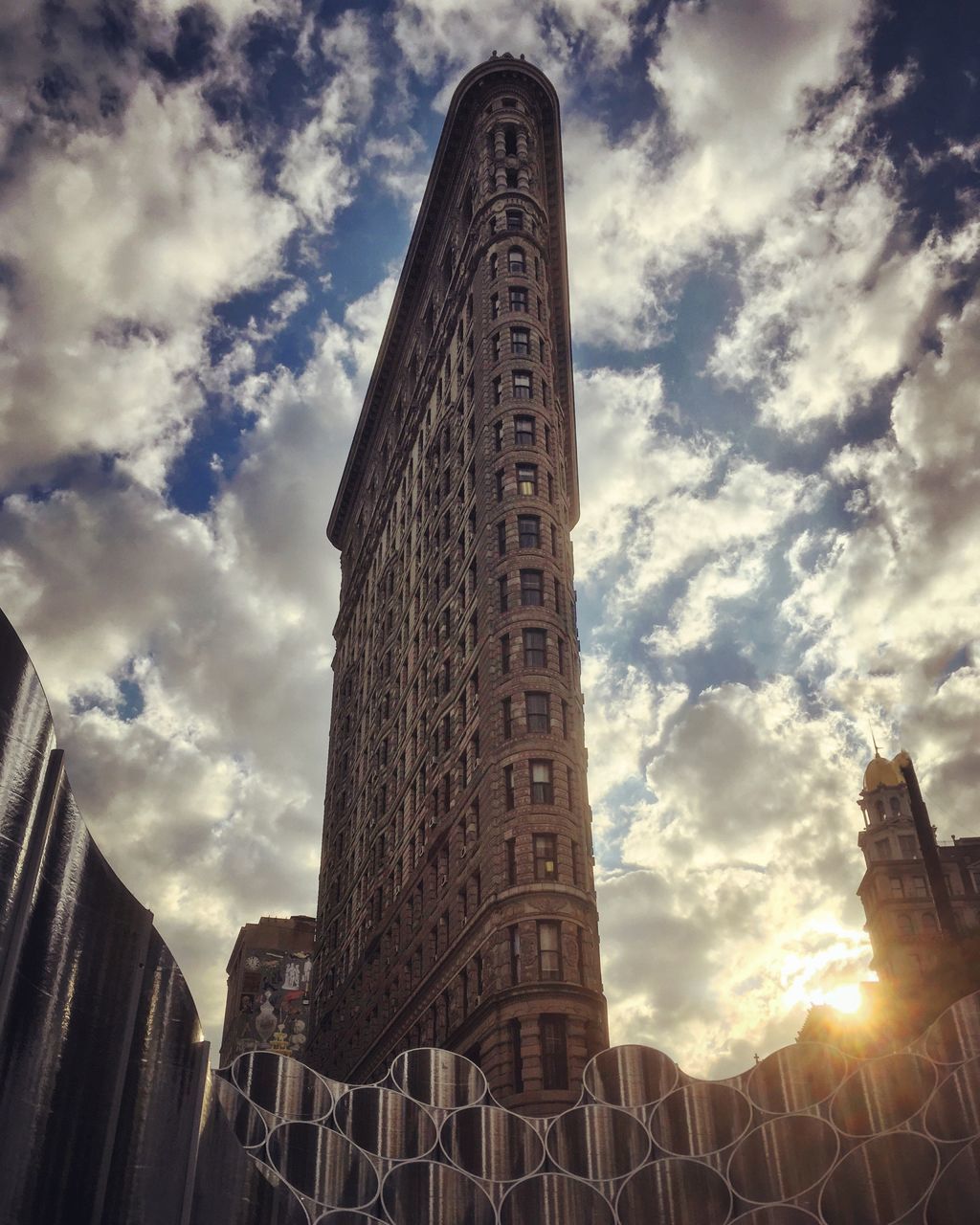 LOW ANGLE VIEW OF SKYSCRAPERS AGAINST CLOUDY SKY