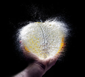 Close-up of human hand against black background