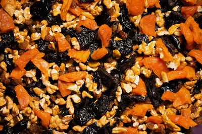 Dried mixture of walnuts and dried fruits, raisins, grapes and prunes close-up
