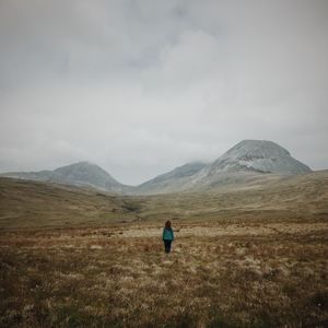 Scenic view of mountains against cloudy sky