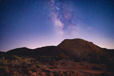 Scenic view of mountains against sky at night