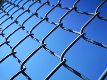 Low angle view of chainlink fence against clear sky