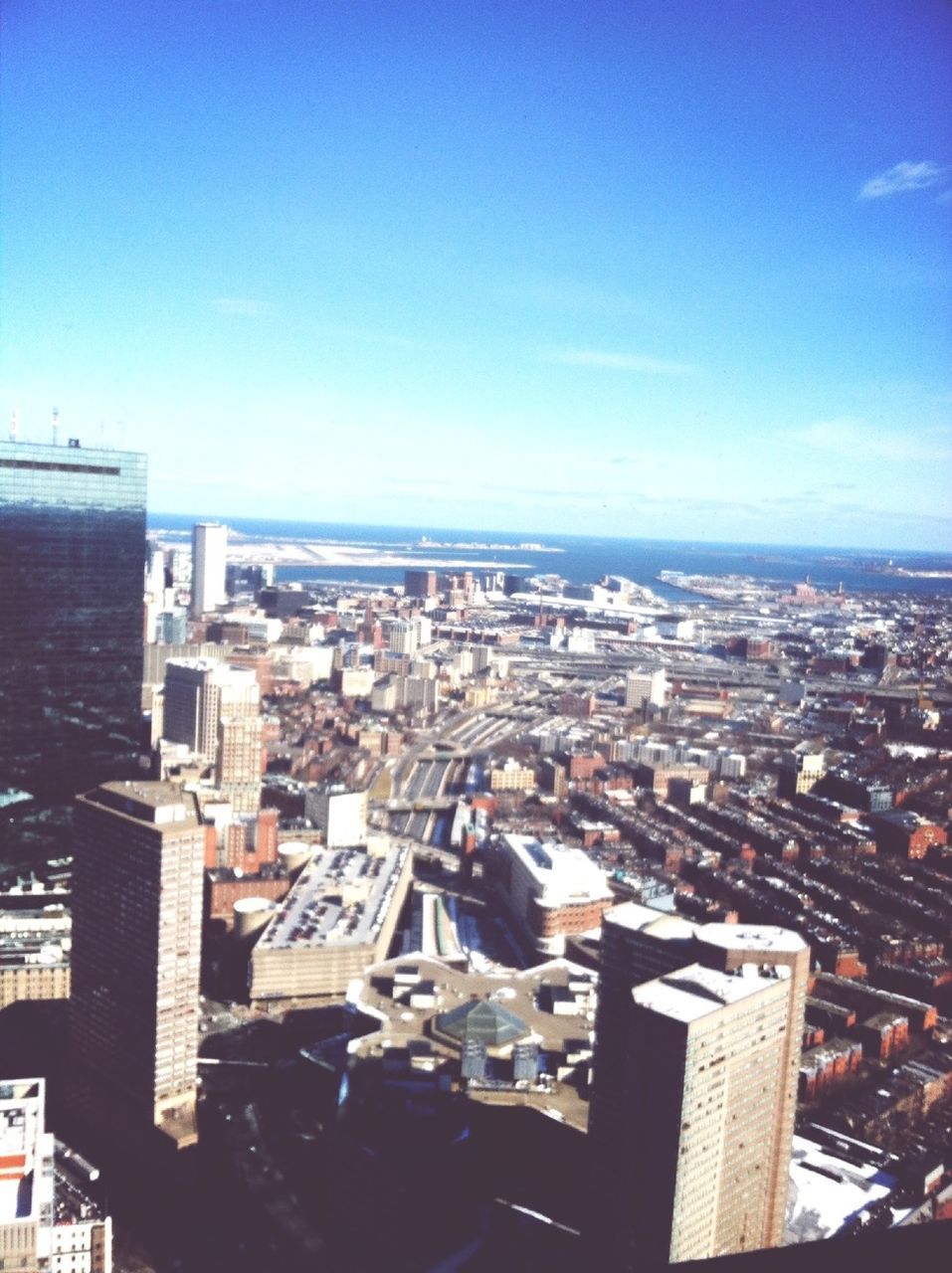 building exterior, architecture, built structure, cityscape, city, crowded, high angle view, residential district, blue, sky, residential structure, residential building, copy space, clear sky, town, day, sunlight, roof, outdoors, no people