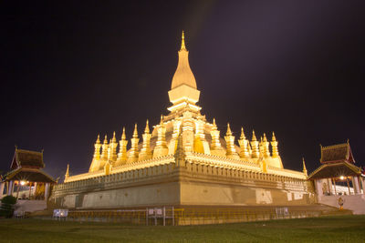 Low angle view of illuminated building against sky at night