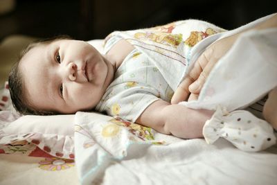 Close-up of baby on bed