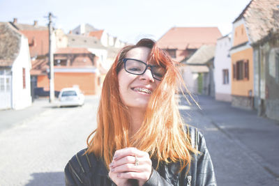 Portrait of smiling woman on street in city