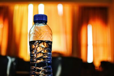 Close-up of water bottle in darkroom