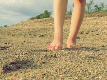 Low section of woman standing on land