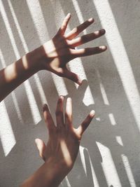 Cropped hands of person against wall