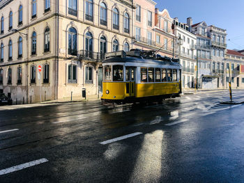 View of yellow street and buildings in city