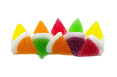 Close-up of multi colored candies against white background